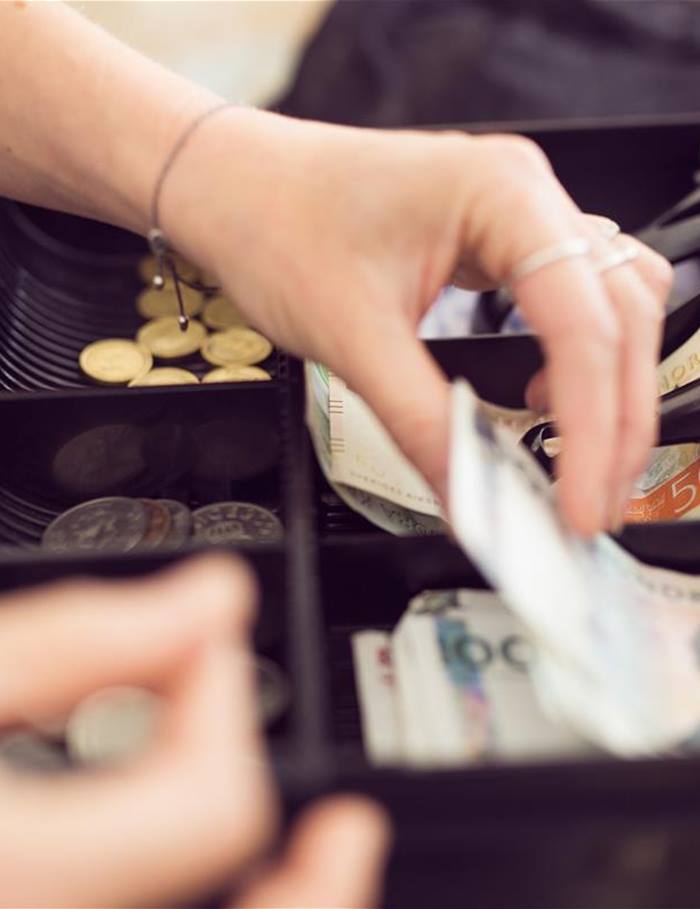 woman-taking-money-from-cash-register-2021-08-28-23-57-32-utc.jpg